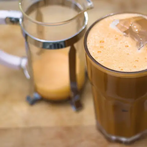 Iced milk tea in a glass next to a pitcher (opens Instagram in a new tab)