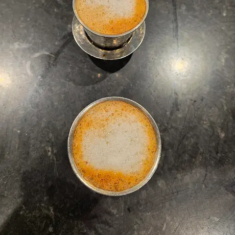 Two steel tumblers of frothy filter coffee (opens Instagram in a new tab)